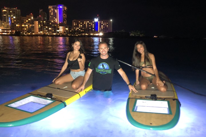 a group of people riding on the back of a boat